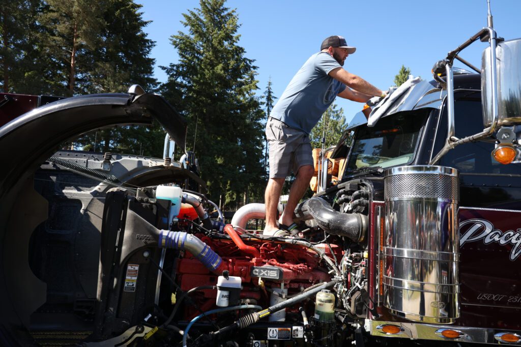 Standing on the engine, Tyson McInnis of Lake Stevens dusts his semi truck.