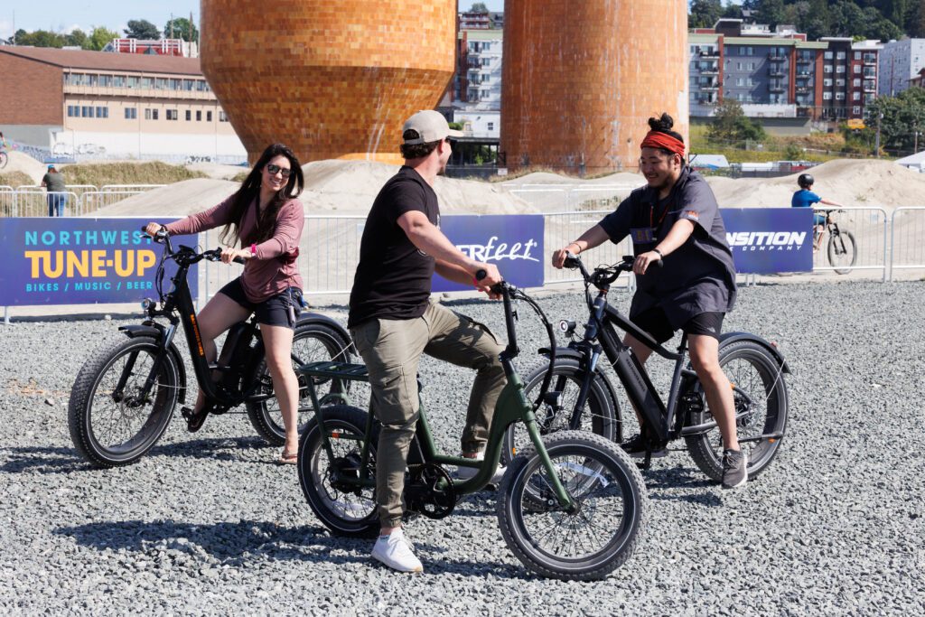 Riders chat while on different e-bikes as they test it on the gravel.