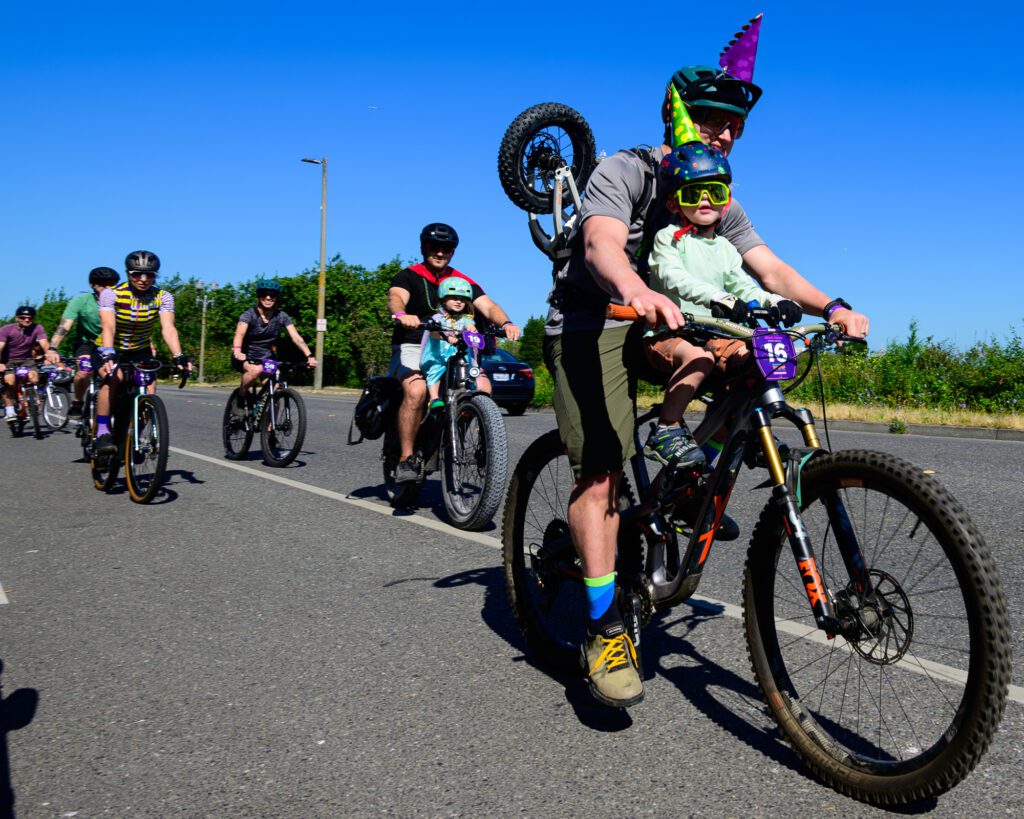 Timothy Schermetzler leads a group of riders out of the Evil Bikes parking lot onto Harris Street in Fairhaven at the start of the Gravel Gran Fundo bike ride on Sunday, July 14.