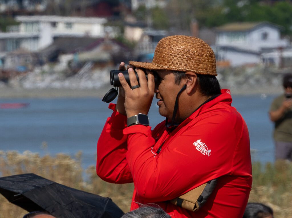 Lummi Nation Vice Chairman Terrence Adams looks for incoming canoes on Monday, July 22 at Birch Bay State Park.