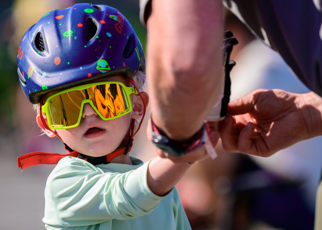 Timothy Schermetzler helps a child with gloves before the ride.