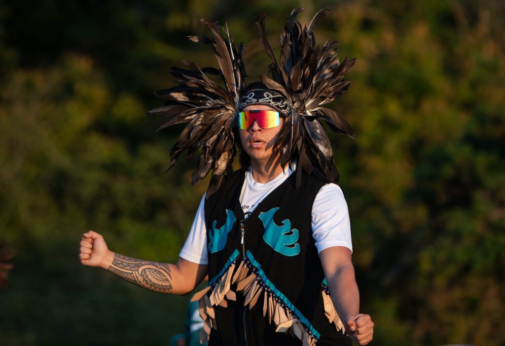 Simon Williams, who traveled from Chilliwack, British Columbia, dances with others at the sun sets at Birch Bay State Park.