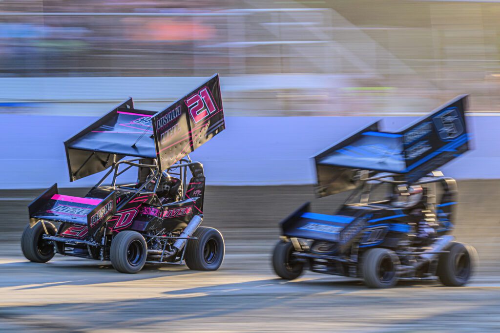 Raio Salmon, left, and Mattix Salmon enter the front straightaway Saturday, July 20 during the 40th annual Clay Cup Nationals at Deming Speedway.