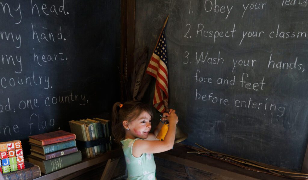 Harper Hamilton, 5, rings a school bell.