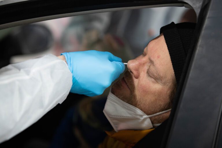 David Powers has his nose swabbed while seated in his car.