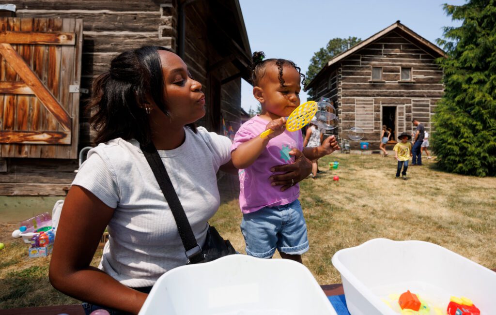 Tekedra Fitch shows her daughter Julia how to blow bubbles.