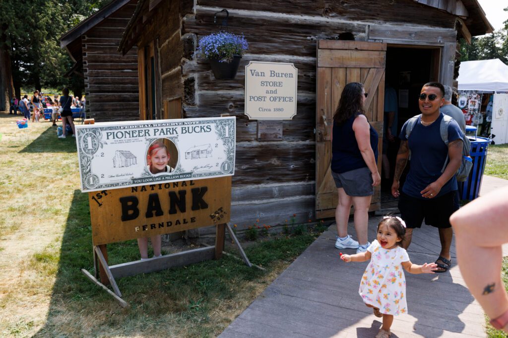 Heidi Beeson pokes her head through a sign.