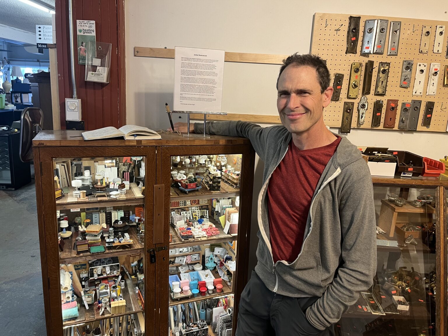 David Spangler stands in front of his diorama Friday, July 26 in The RE Store in Bellingham. As children, Spangler and his brother began collecting and stowing away trash to be made into later treasure in their "neat things" box.