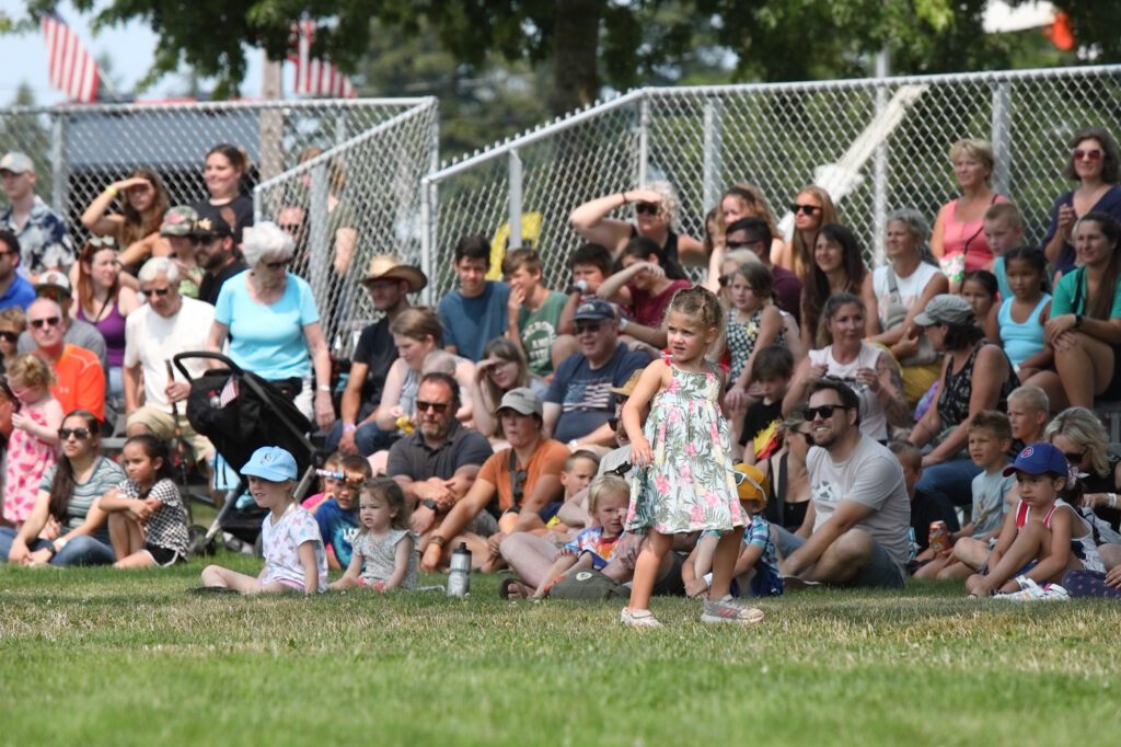 Dozens of people watched the Cyber Cirque — a display of acrobatic feats on the lawn outside the animal barns.