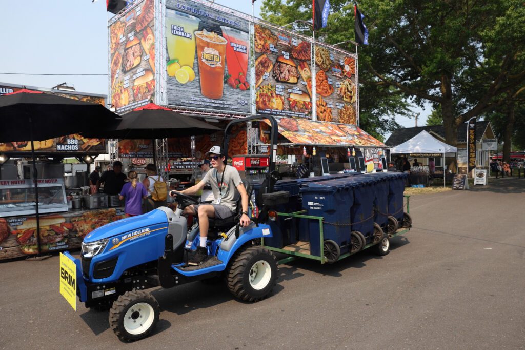 A trash monitor drives trash cans around the fairgrounds, keeping them clean.