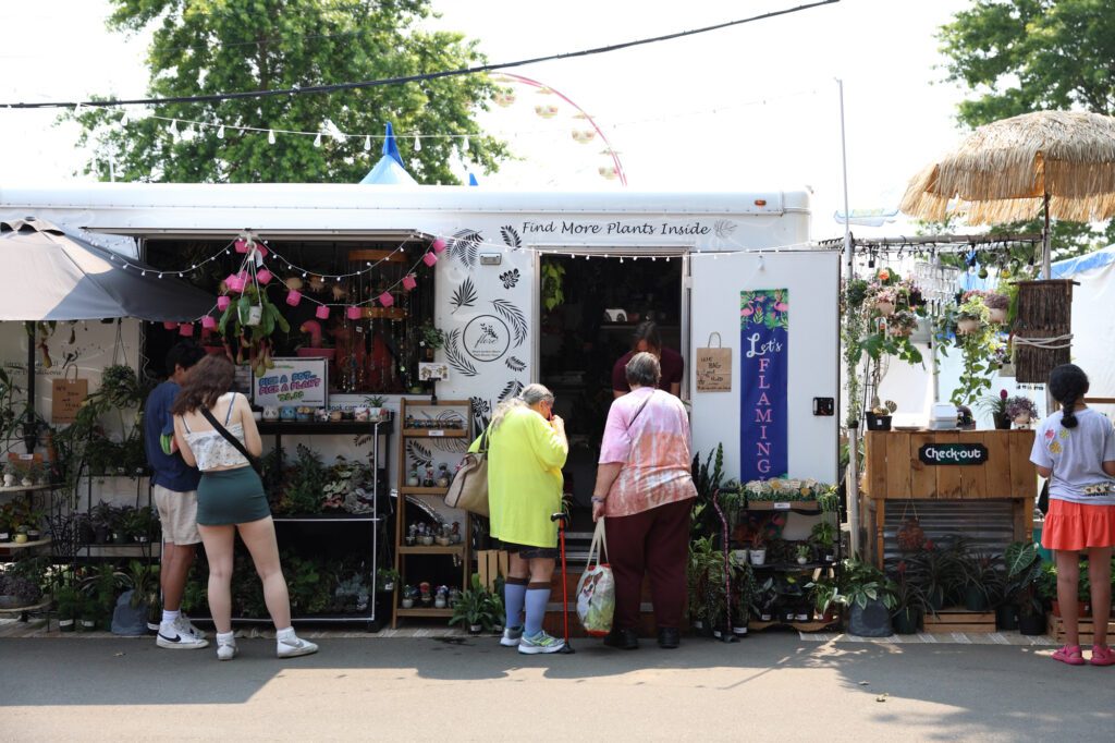 People look at plants at Flore, one of many vendors at the fair.