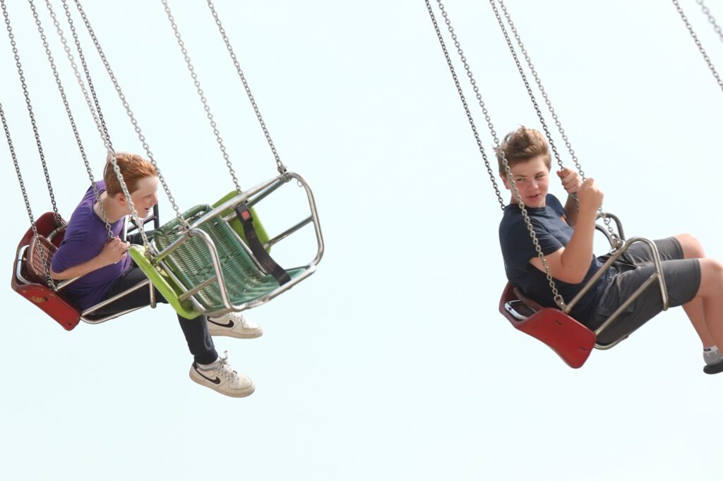 State Rep. Alicia Rule's sons Elliot, left, and Oliver ride the giant swing.