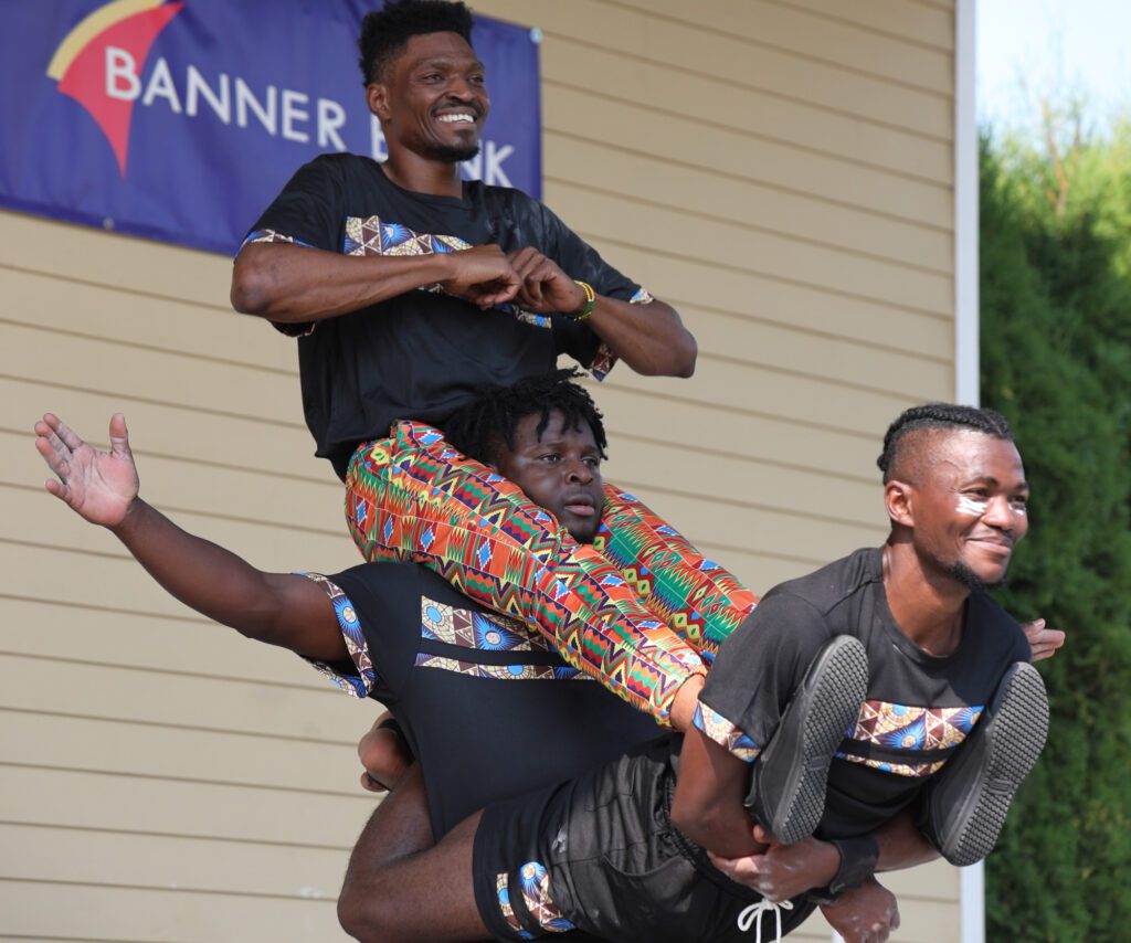 The Zuzu Acrobats balance on one another at the end of a set of acrobatic feats. The troupe from Tanzania performs twice a day on the Banner Bank stage at the Northwest Washington Fair.