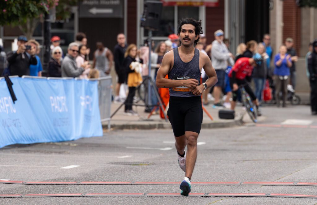 Nooksack Valley cross country coach Adrian Cedillo reclaims his first place overall finish with a time of 2:45:12.