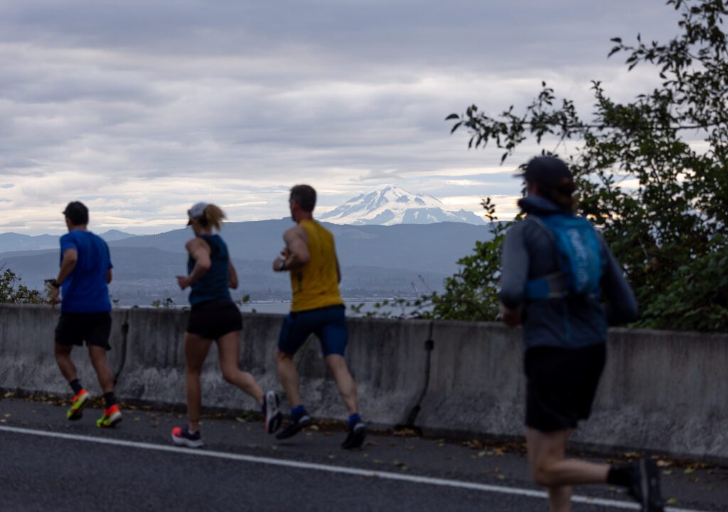 Runners pass by Mount Baker as they head north on Lummi Shore Road.