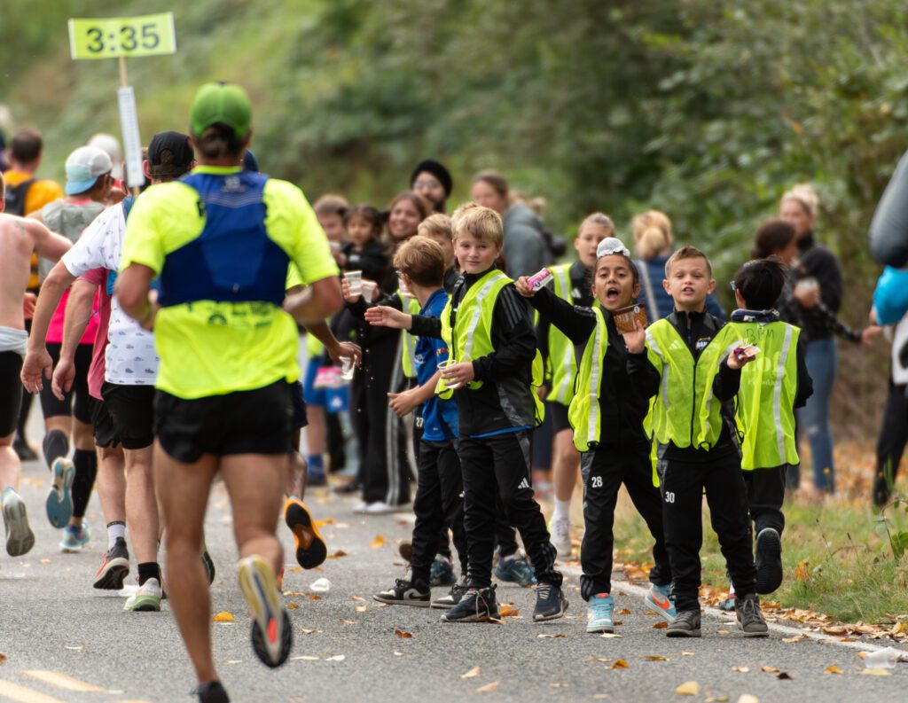 Members of the Whatcom FC Rangers pass out water, electrolyte drinks and energy gels along the marathon route.