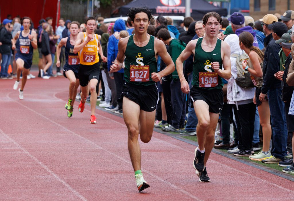 Sehome’s Sebastien Vahid and Nick Gargano race to the finish line in the senior boys race Saturday, Sept. 14 at the Gear Up Northwest XC Preview meet at Civic Stadium.