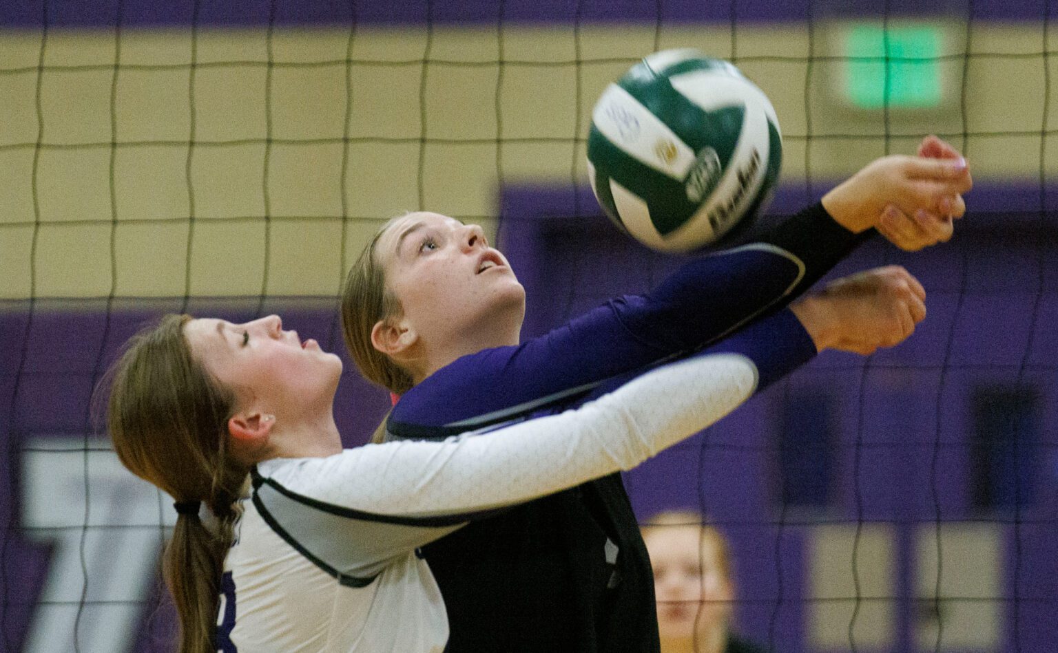 Nooksack Valley’s Avery Juergens and Gracie Rutgers collide as they reach for the bump.