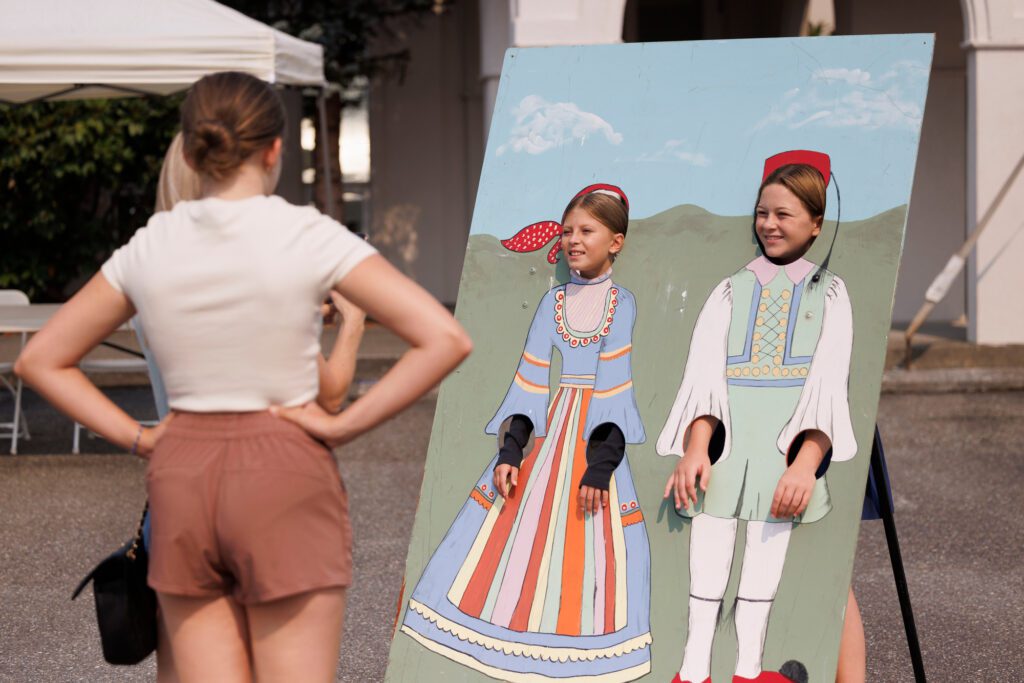 Daphne Rosinski and Stella Shepard pose in a cutout of traditional Greek costumes.