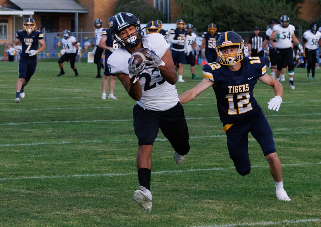 Mount Vernon's Moises Lucatero hauls in a pass under pressure from Burlington-Edison's Jace Taxdahl.