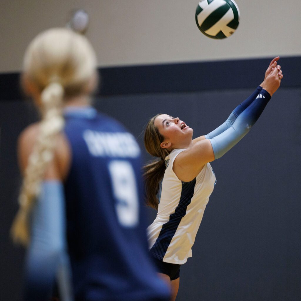 Lynden Christian’s Lyla Parriera reaches to save a point.