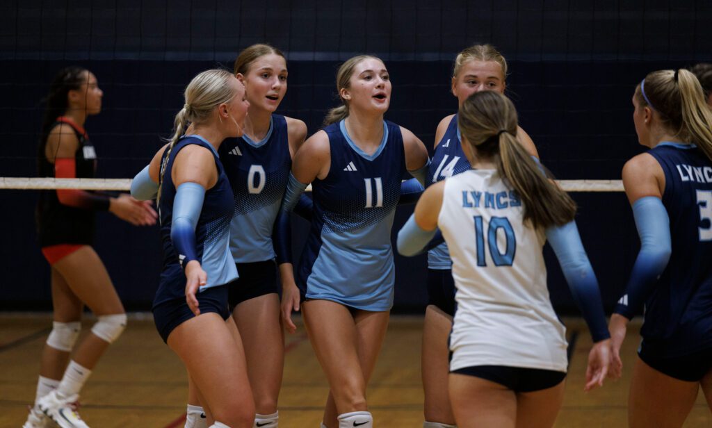 Lynden Christian players celebrate beating Bellingham in three straight sets.