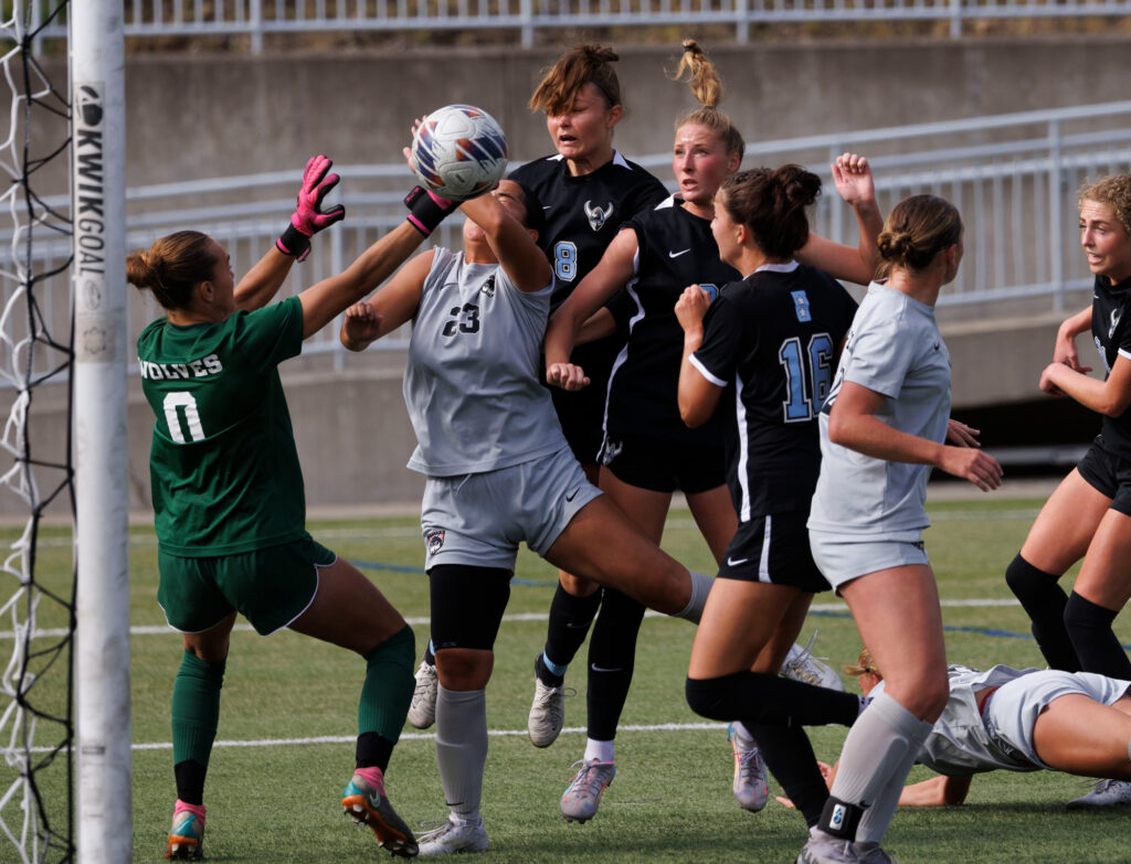 Western Washington University's Krysten McGuffey, center, watches her header get past the goalie Saturday, Oct. 5 as the Vikings tied Western Oregon 1-1 at Harrington Field.