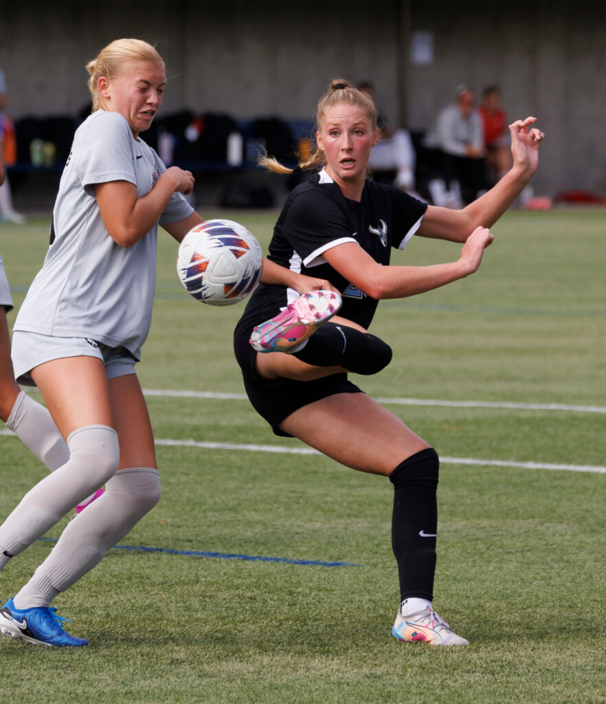 Western's Krysten McGuffey kicks backwards to send the ball towards the goal.