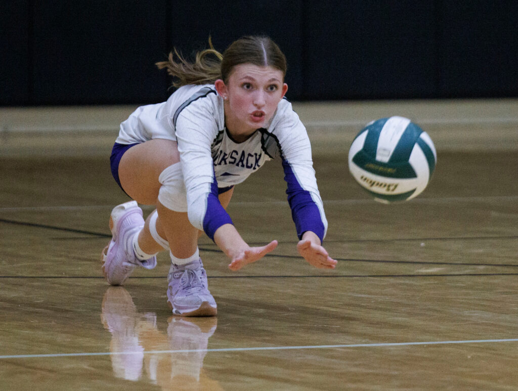 Nooksack Valley’s Avery Juergens dives for a dig but comes up short.