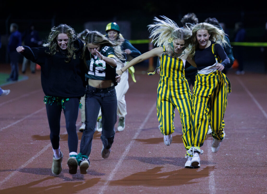 Sehome students race to the finish line during a two-legged race at halftime.