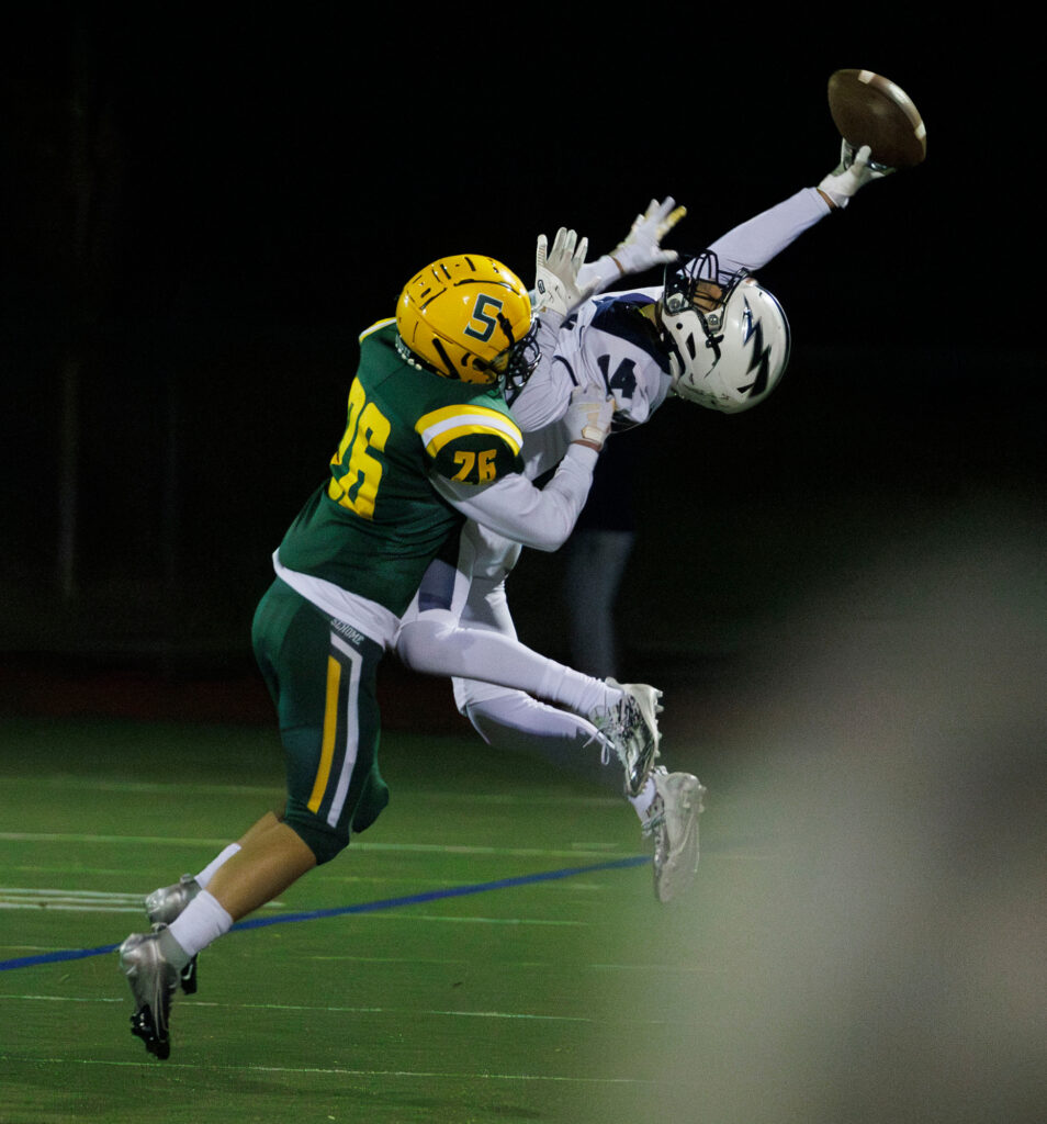 Squalicum's Ansen Asbjornsen reaches back for a pass but drops it under pressure from Sehome’s Kyle Neyer.