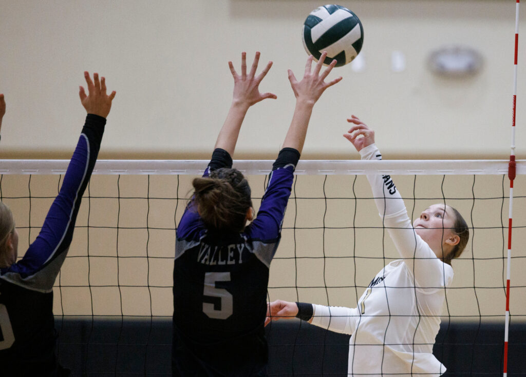 Meridian's Eden Bernardy sends the ball over Nooksack Valley blockers.