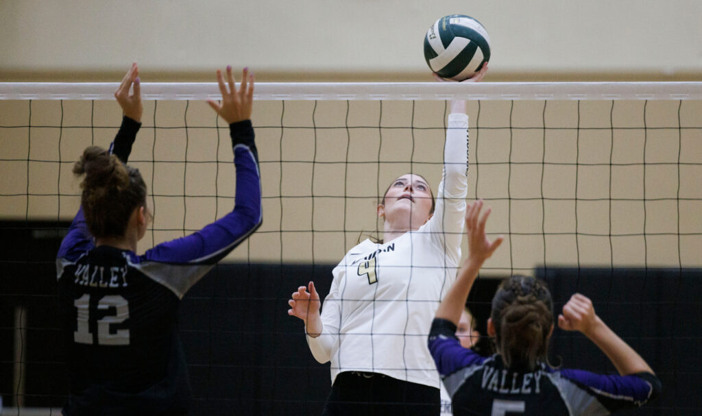 Meridian’s Taya Benson tries to lift the ball over the net.