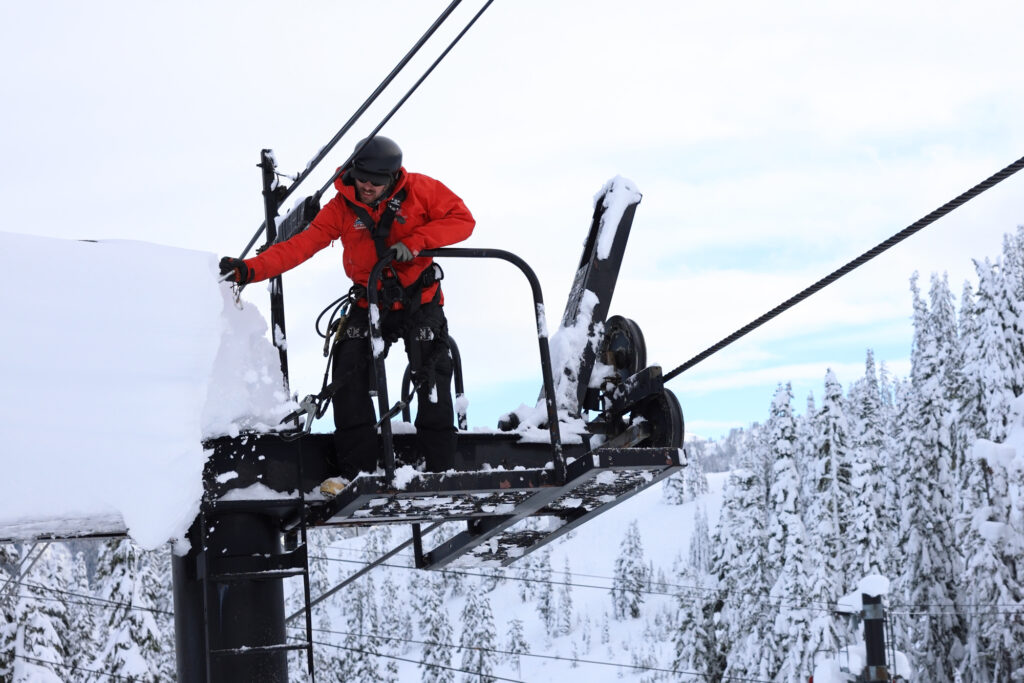 A Mt. Baker Ski Area worker clears several feet of snow off of a lift tower.