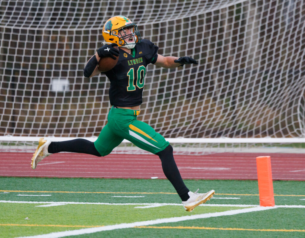 Lynden’s Brody Price celebrates as he runs in for the Lions’ only touchdown.