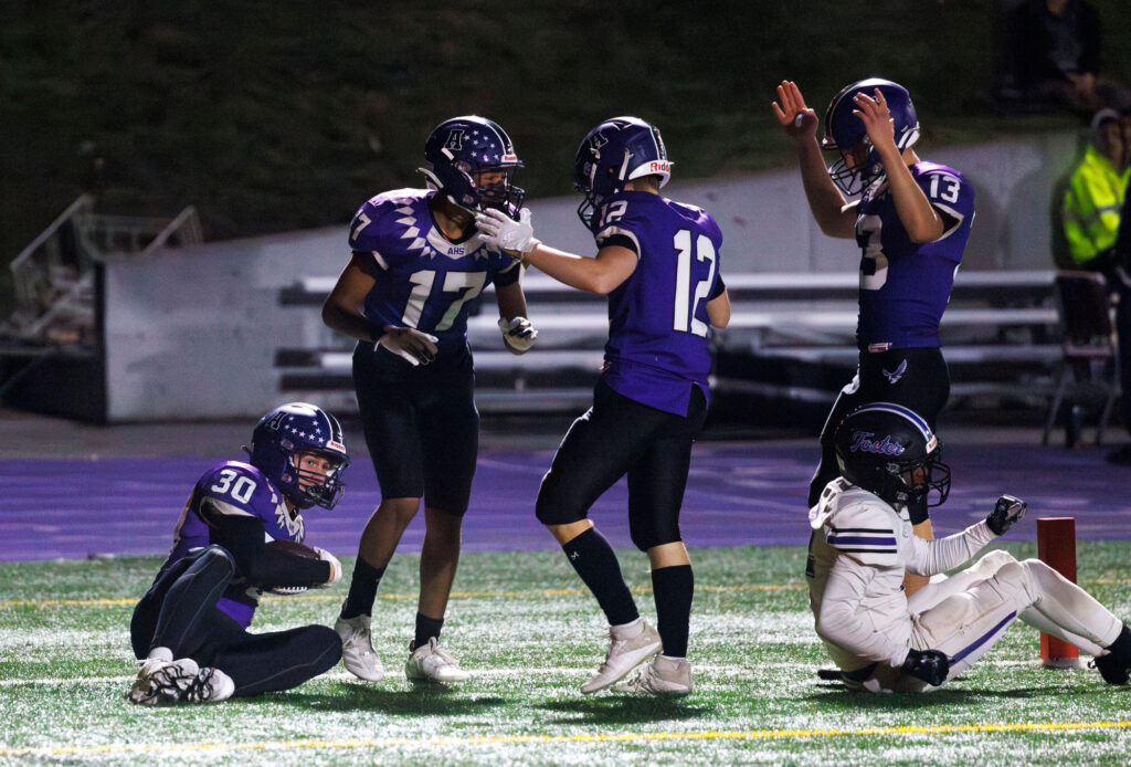 Anacortes players celebrate after teammate Wesley Green grabbed a mishandled kickoff return and fell into the end zone. However, it was ruled he was down short of the goal.