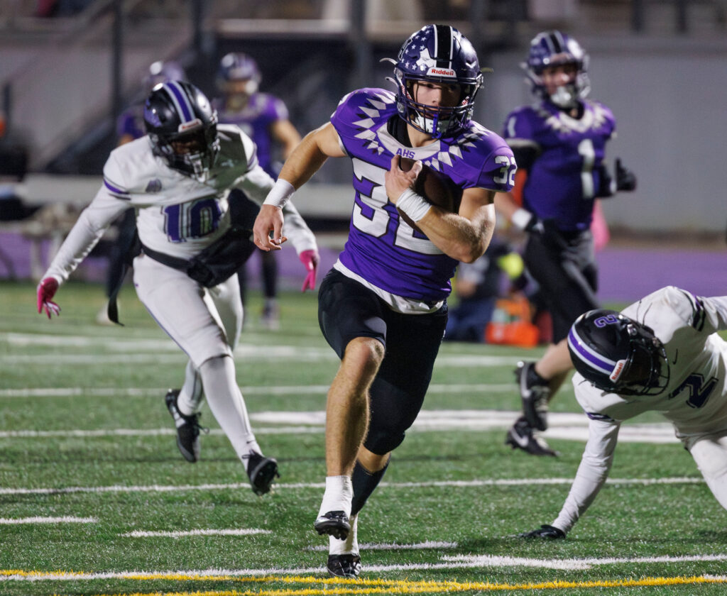 Anacortes' Brock Beaner rolls in for a 40-yard touchdown Friday, Nov. 8 as Anacortes beat Foster 77-12 in a state play-in game at home.