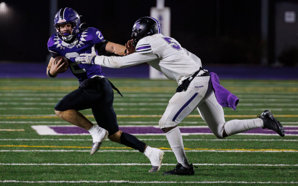 Anacortes' Brady Beaner avoids a tackle as he runs for a first down.