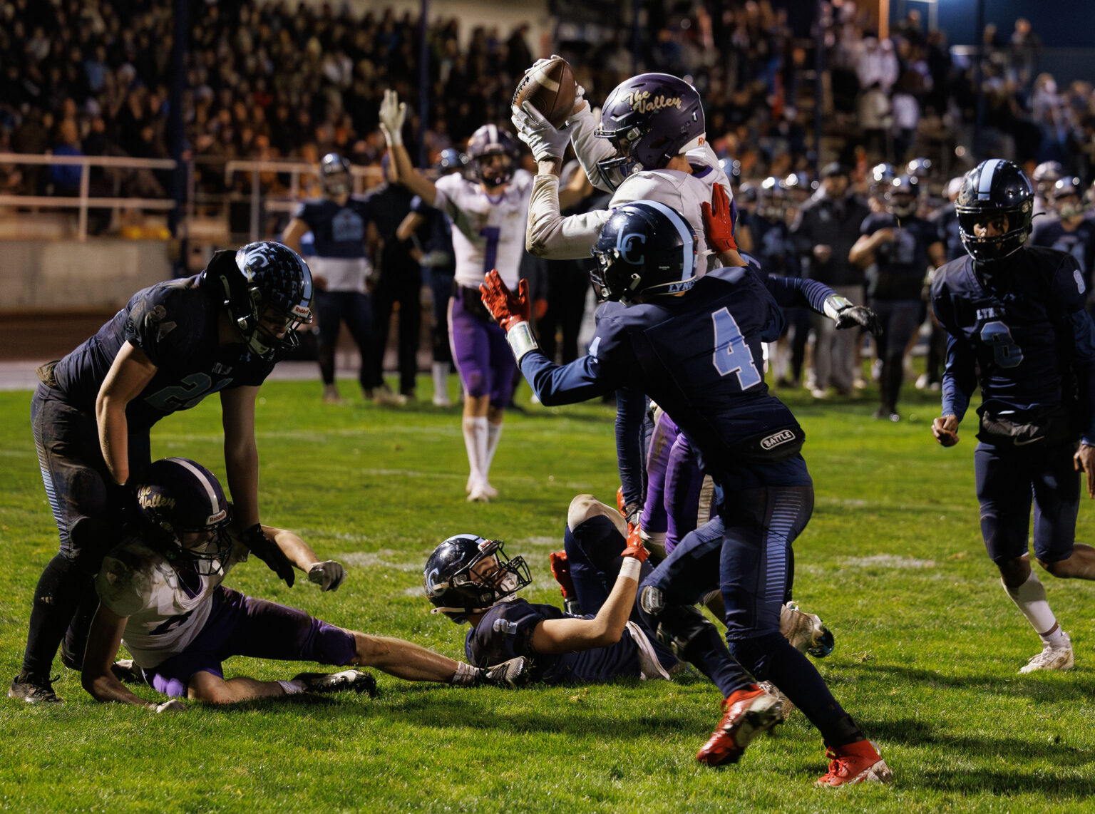 Nooksack Valley's Cole Bauman grabs the ball in the end zone after it has batted in the air as other players tumble on the play. The touchdown was called back on a penalty.