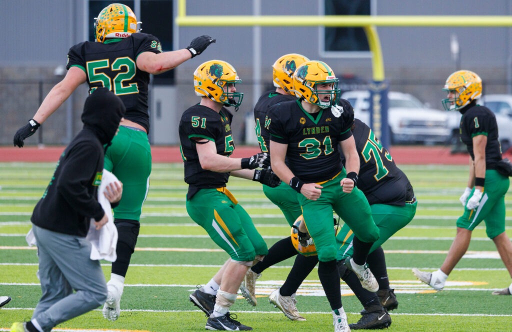 Lynden players celebrate a fumble recovery.