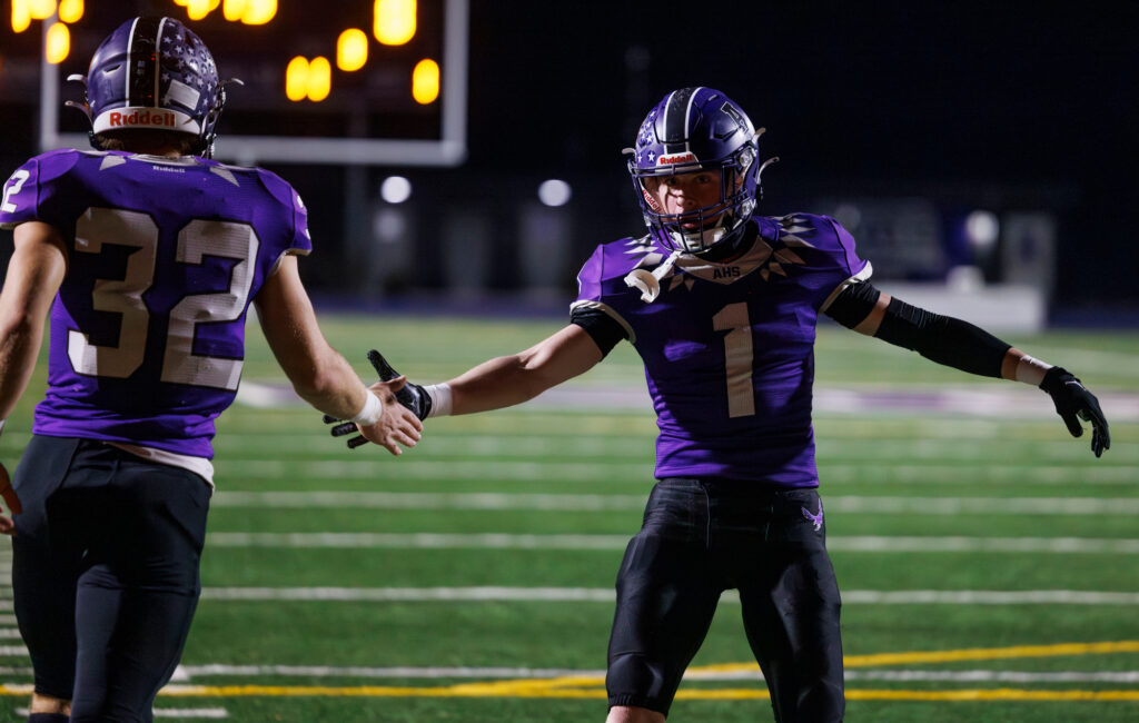 Anacortes' Luca Moore congratulates teammate Brock Beaner after Beaner's touchdown.