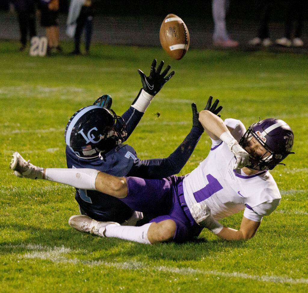 Lynden Christian's Boyce Robertson reaches but can’t hold the ball as he and Nooksack Valley's Cole Coppinger fall in the end zone.