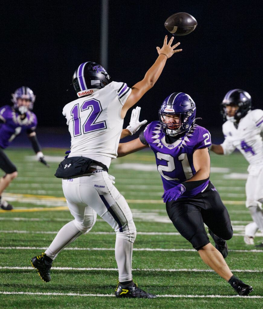 Anacortes' Jack Hopen pressures Foster's quarterback.