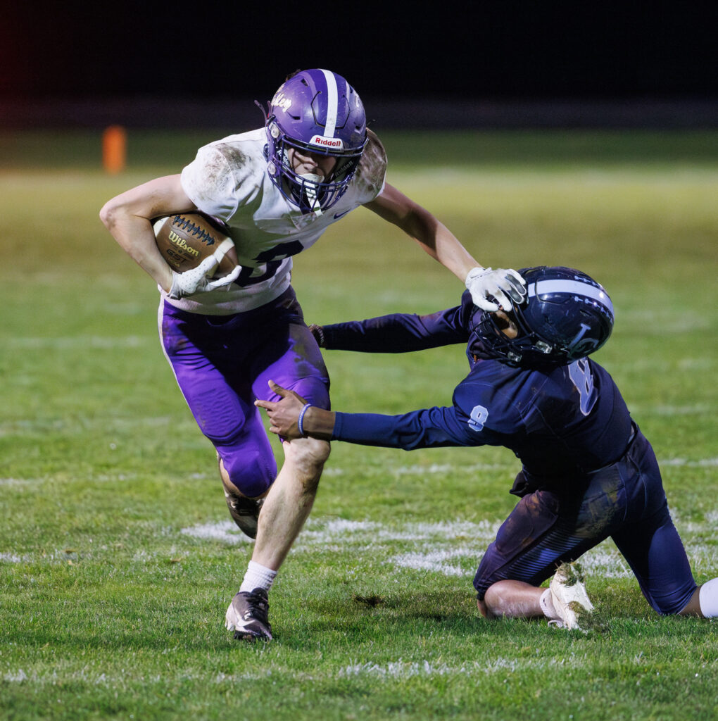 Nooksack Valley's Cory Olney pushes off Lynden Christian's Jacob Penner to get the first down.