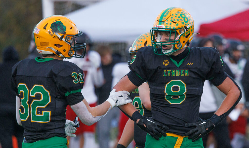 Lynden’s Isaiah Oudman (8) gets few words of encouragement from teammate Maximus Assink after a failed two-point attempt.