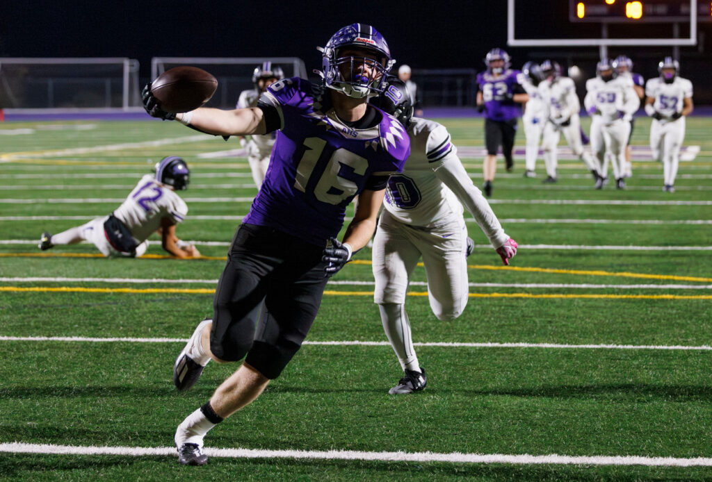 Anacortes' Micah Dickison rolls in for a touchdown.