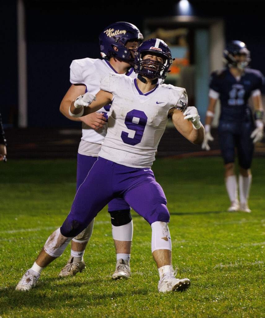 Nooksack Valley's Colton Lentz yells and pumps his arms after scoring a touchdown early in the game.