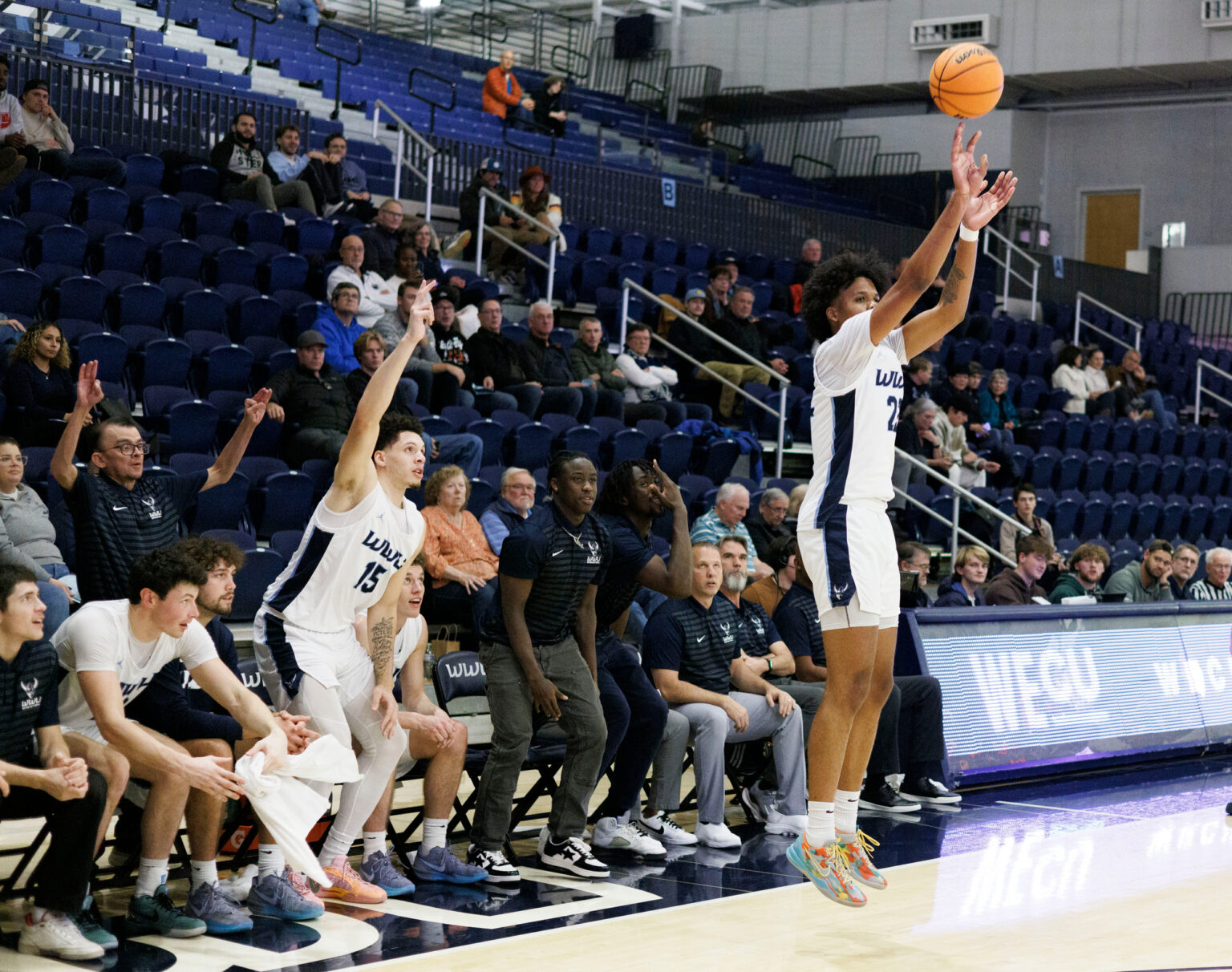 Teammates get ready to celebrate a 3-point shot by Dajon Lott.