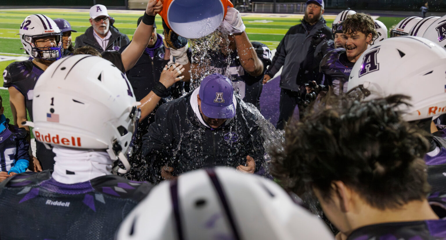 Anacortes head coach Justin Portz gets doused by his players after beating W.F. West.