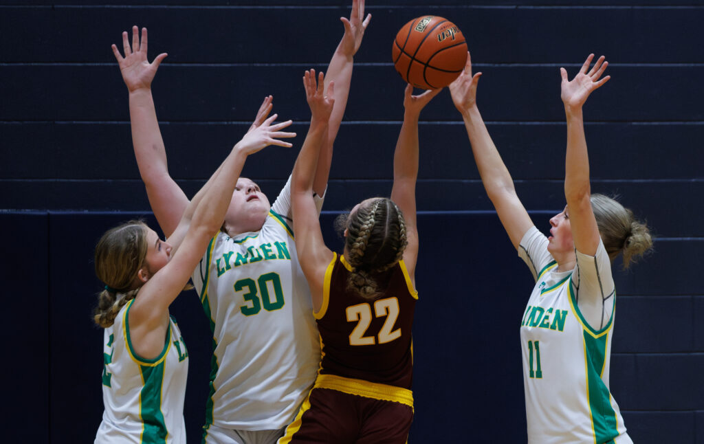 Lynden’s Finley Parcher, Payton Mills and Rian Stephan block a White River shot Dec. 28 as the Lions beat the Hornets 72-51 to win the Lynden Christmas Classic at Lynden Christian High.